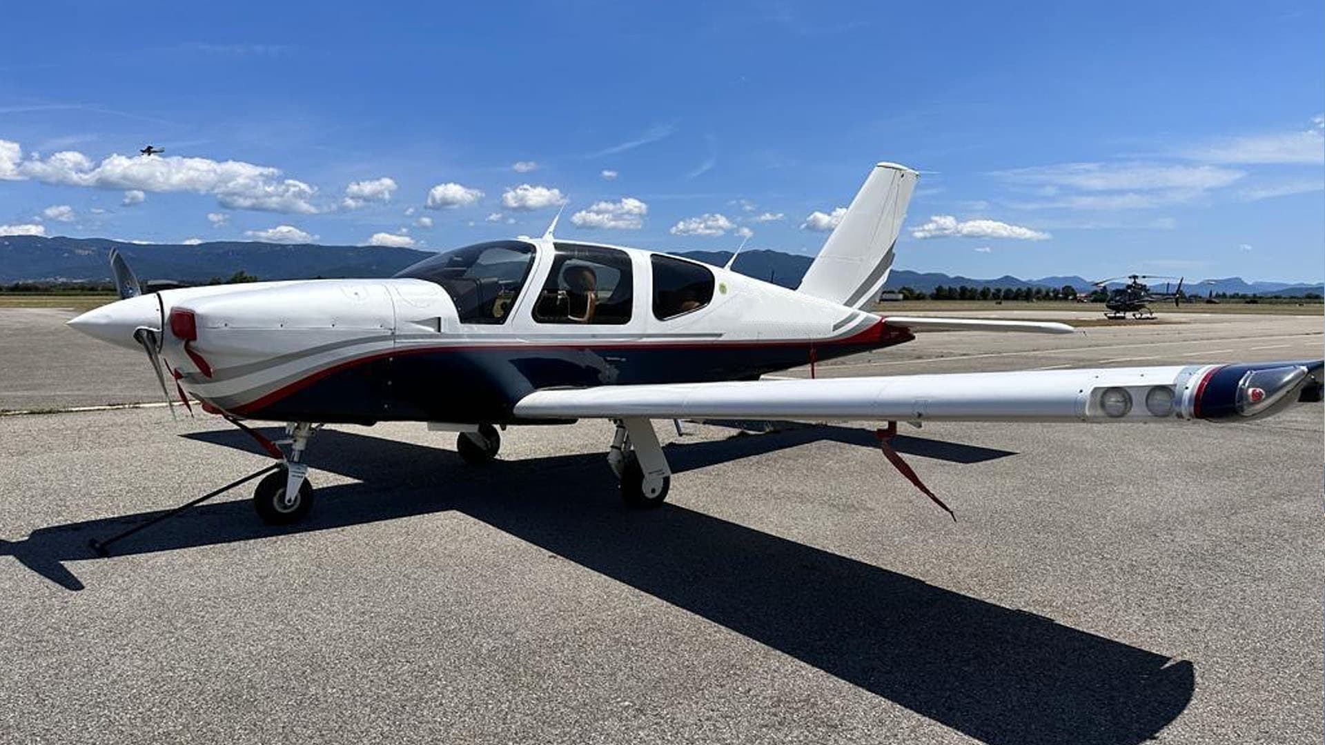 SOCATA TB20 single-engine touring aircraft parked on the apron