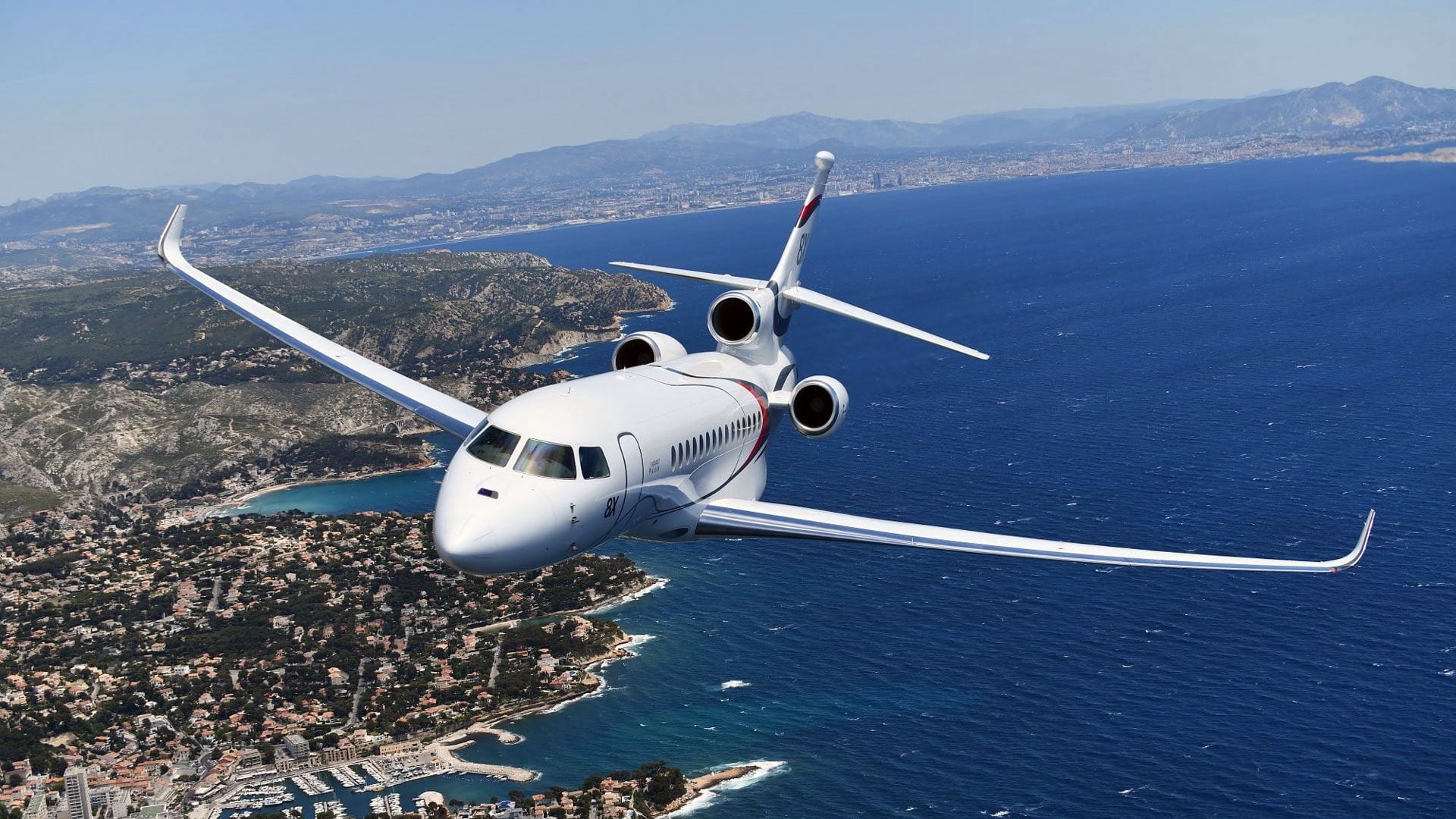 Dassault Falcon 8X ultra long range private jet with spacious luxury cabin in flight